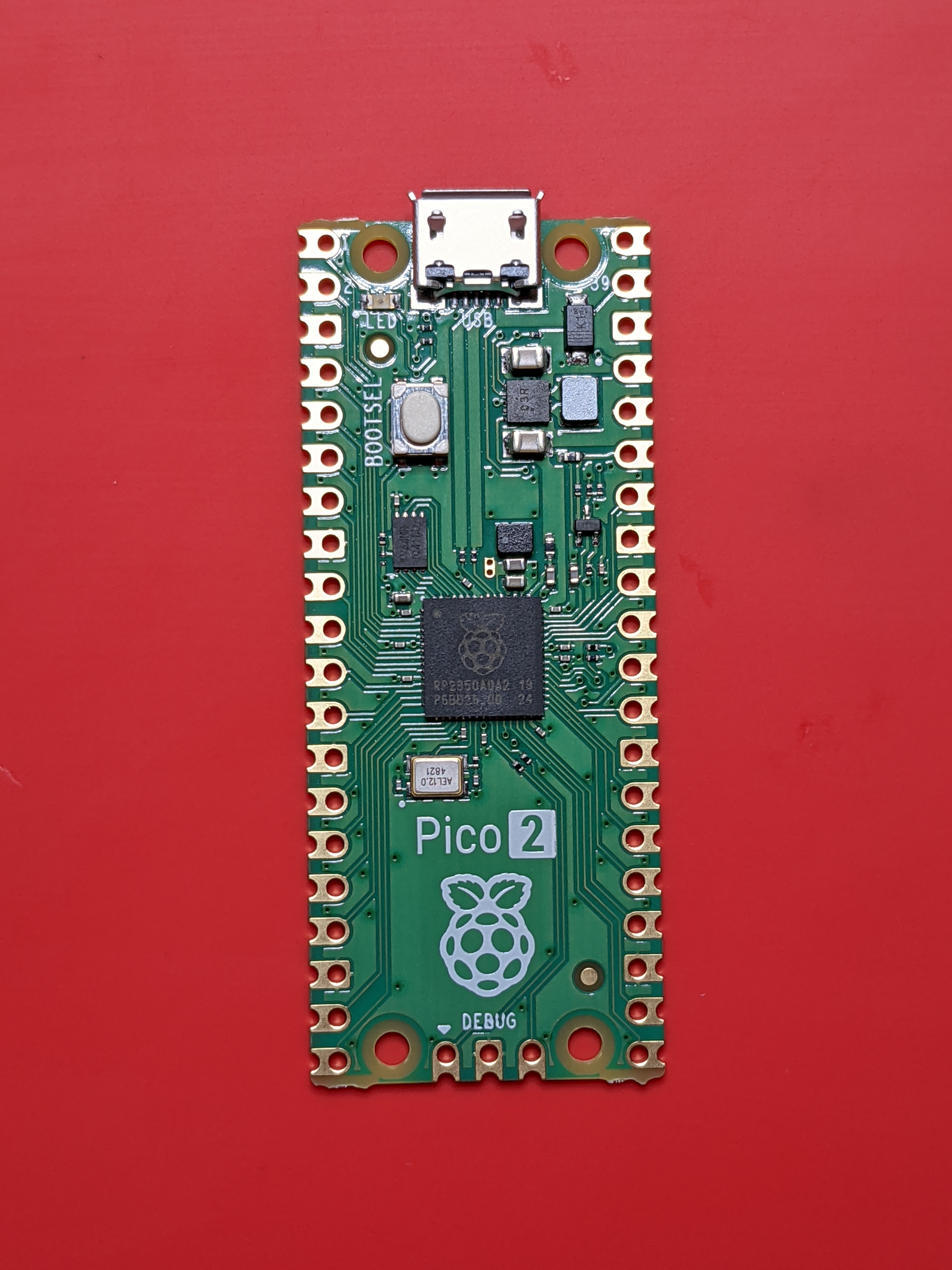 Figure 2 — Raspberry Pi Pico 2 (RP2350), top view. Same physical footprint as the original Pico, with the RP2350 SoC under the silkscreened logo.