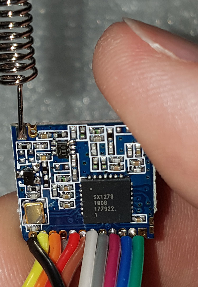 Figure 3 — A LoRa transceiver module with whip antenna and SPI flying leads. Functionally equivalent topology to the RFM95W: SX127x family transceiver, 100 mW TX, FSK or LoRa modulation.